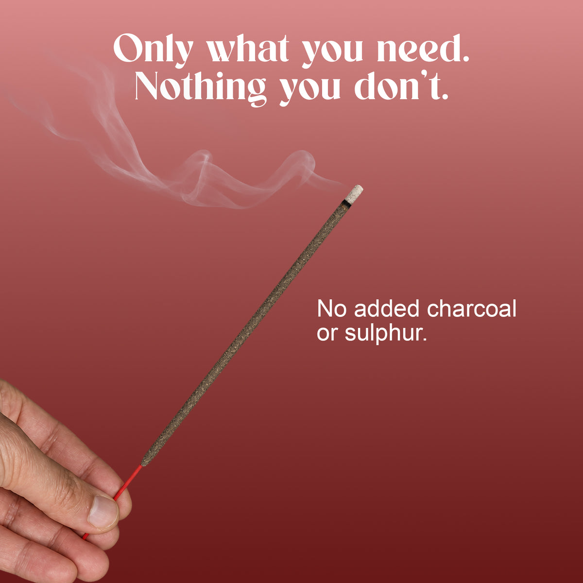 Hand holding a lit Amira Rose incense stick: no added charcoal or sulphur