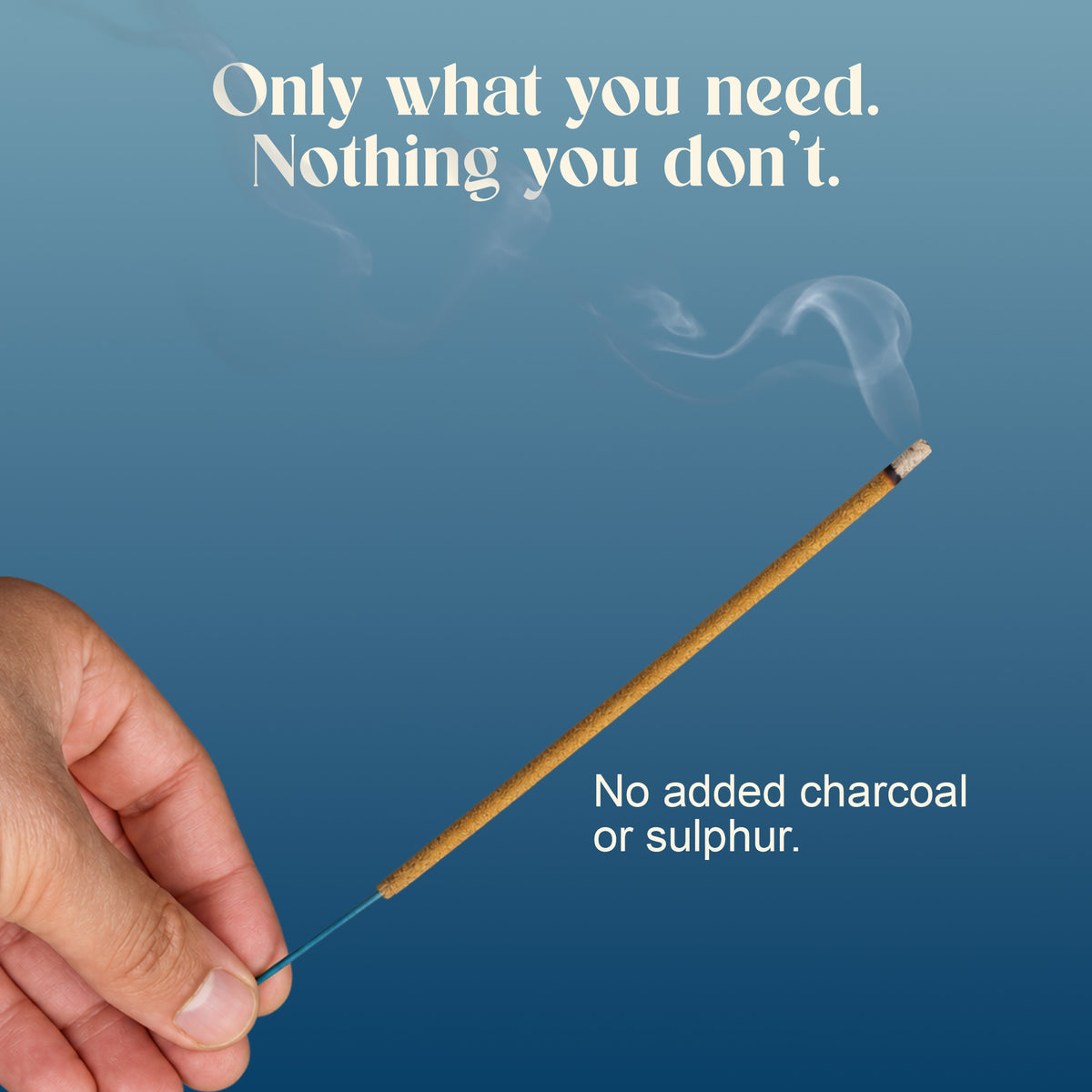 Hand holding a lit Royal Musk incense stick: no added charcoal or sulphur