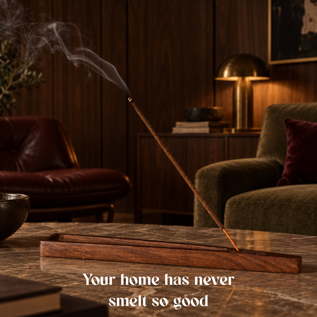 Khalira incense stick burning in a rosewood holder in a dark lounge with an armchair