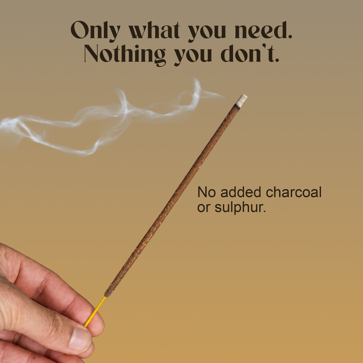 Hand holding a lit Chandara incense stick: no added charcoal or sulphur